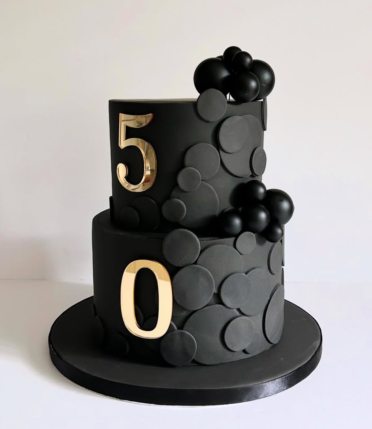 Black and gold 50th birthday tiered cake